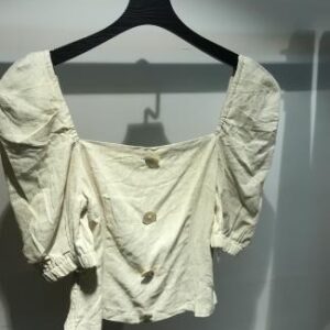 Blusa blanca con mangas abullonadas y botones frontales